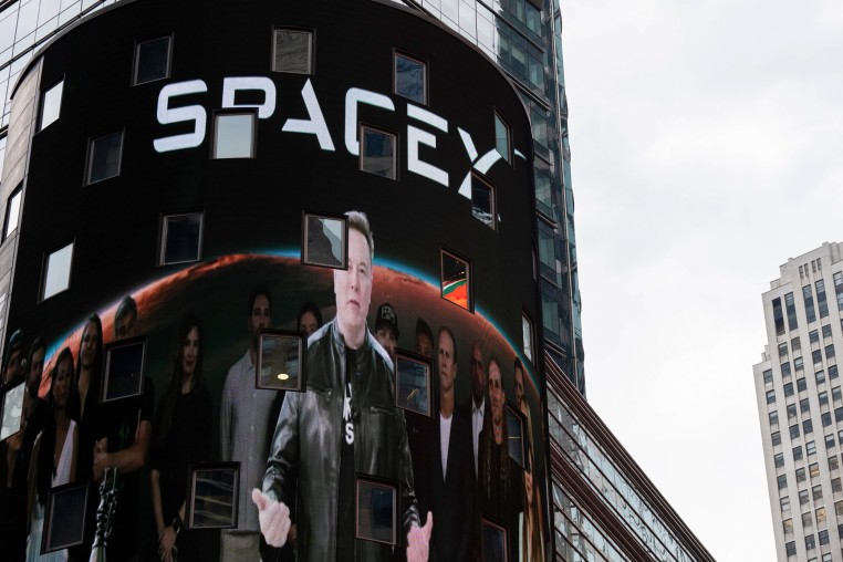 Elon Musk on screen in Times Square.