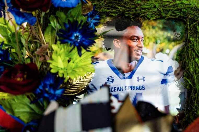 A photo of Nolan Wells surrounded by flowers 