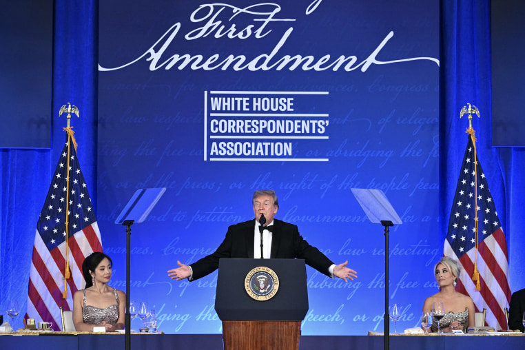 Donald Trump speaking at a lectern bearing the presidential seal.