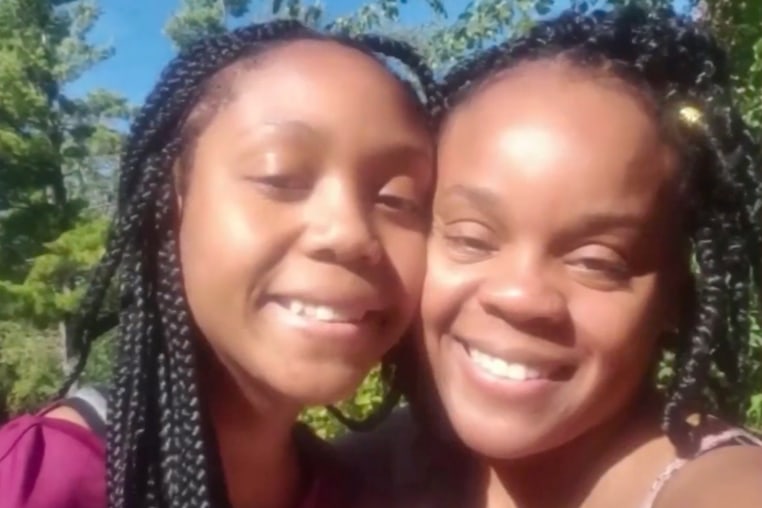 Joniah Walker, left, and her mother Tanesha Howard press their cheeks together for a photo outside