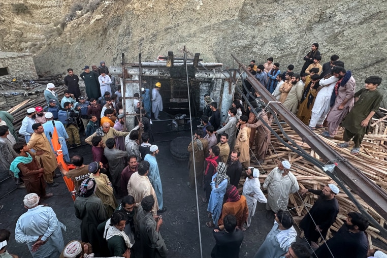 People gather outside a coal mine in Pakistan.