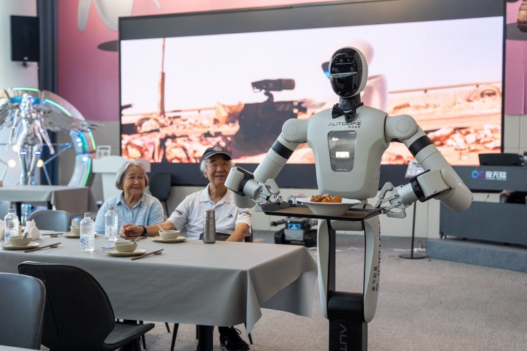 A humanoid robot serve a dish at the AI restaurant of the Global Pioneer AI Hub on Thursday, July 23, 2026 in Shenzhen, China.