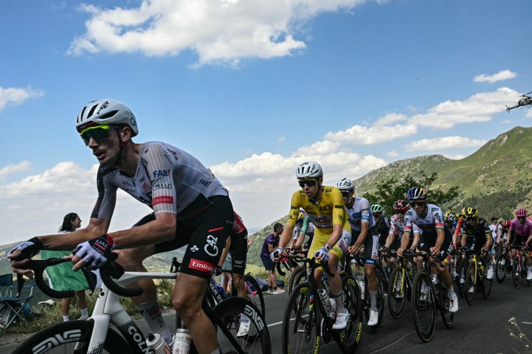 UAE Team Emirates - XRG's Slovenian rider Tadej Pogacar wearing the overall leader's yellow jersey cycles with the pack of riders (peloton) during the 10th stage of the 113th edition of the Tour de France cycling race, 166,6 km between Aurillac and Le Lioran in the Massif Central, on July 14, 2026. (Photo by Loic VENANCE / AFP via Getty Images)