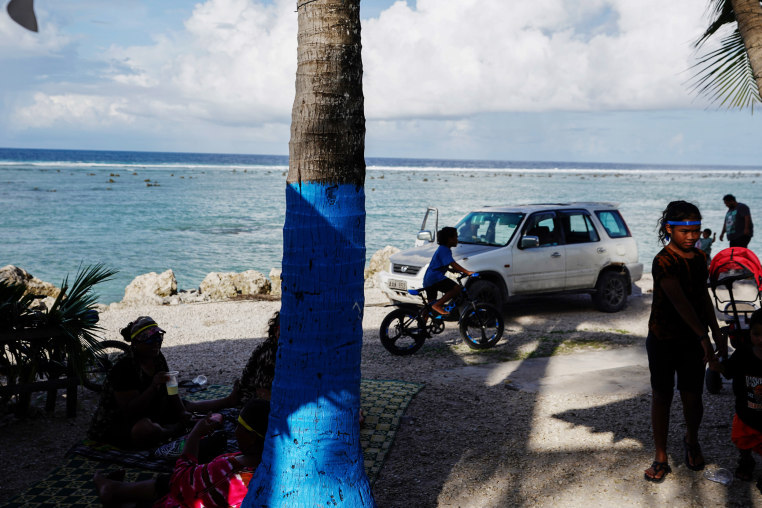 People enjoy their leisure time by the sea.
