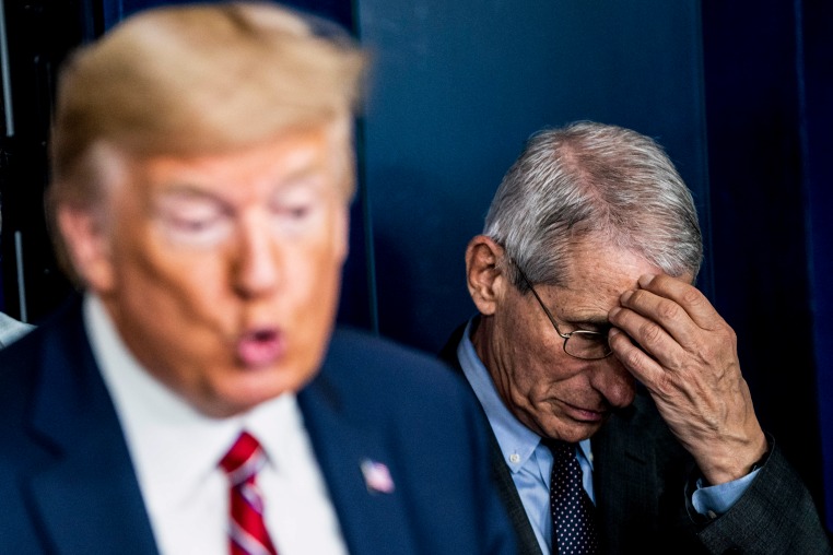 Anthony Fauci listen as Donald J. Trump.
