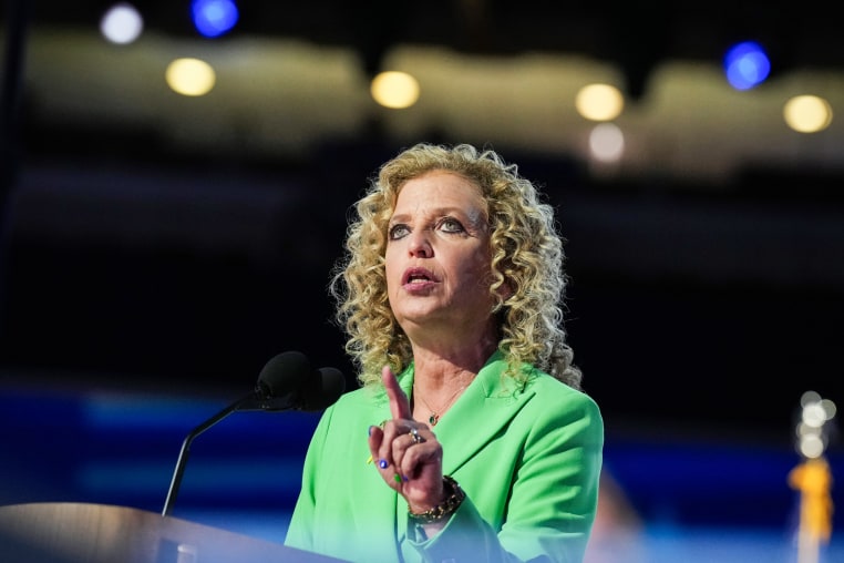 Debbie Wasserman Schultz speaks at a podium in an arena