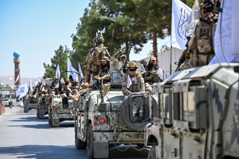 A convoy of Taliban security personnel take part in a parade.