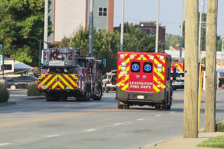 A fire truck and emergency vehicle are seen on the street