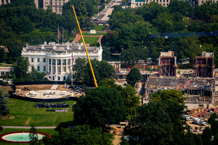 Construction continues on a new helipad on the South Lawn of the White House and the East Wing ballroom.