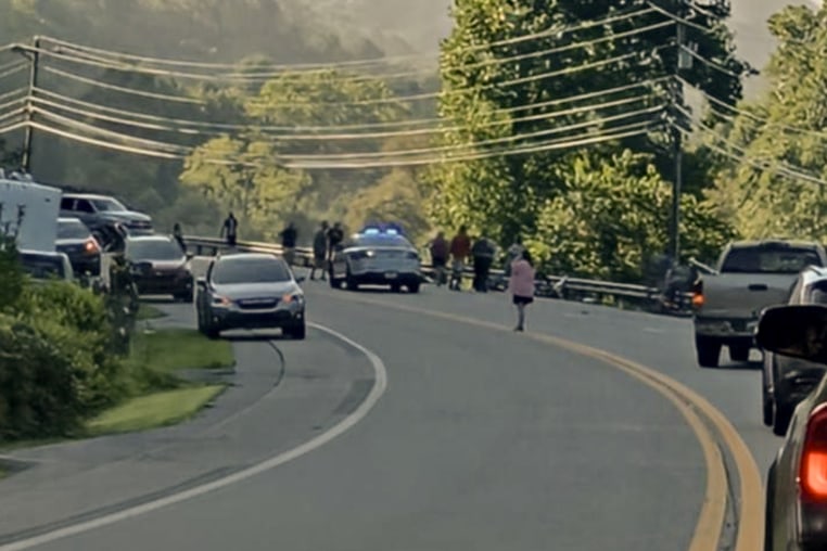 Traffic stopped along Highway 19 in Carter County, Tenn. at the scene where two Tennessee college team cyclists were killed by a motorist while training on Aug. 19, 2026.