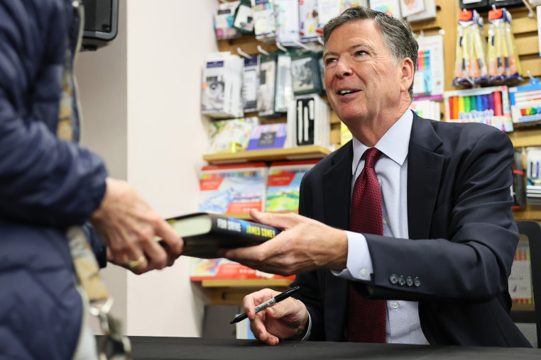  James Comey signs copies of his crime novel "FDR Drive" in New York in 2025.