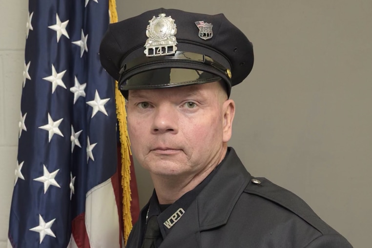 Kurt Solomon poses for a photo in his police uniform