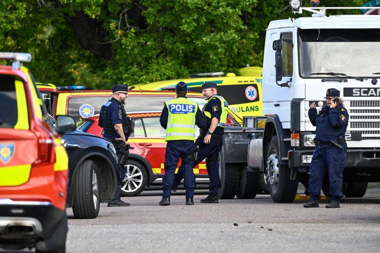 Police officers and rescue services work at the scene.