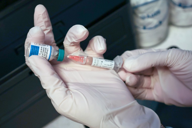 A Medical Assistant draws a measles, mumps and rubella vaccine.