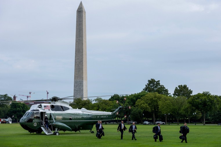 United States Secret Service agents walk away from a helicopter. 