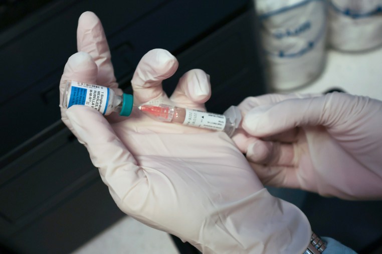 A Medical Assistant draws a measles, mumps and rubella, vaccination.