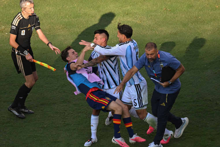 EAST RUTHERFORD, NEW JERSEY - JULY 19: Leandro Paredes #5 and Thiago Almada #16 of Argentina throw Pablo Gavi #9 of Spain to the ground after the FIFA World Cup 2026 Final match at New York New Jersey Stadium on July 19, 2026 in East Rutherford, New Jersey. (Photo by Howard Smith/ISI Photos/ISI Photos via Getty Images)