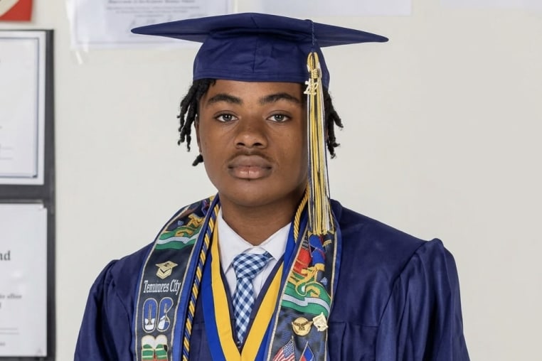A young man wearing a cap and gown. 