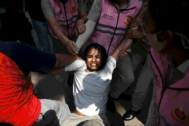 Image: A carousel of photos from protests in New Delhi, India, predominantly showing clashes between protesters and police.