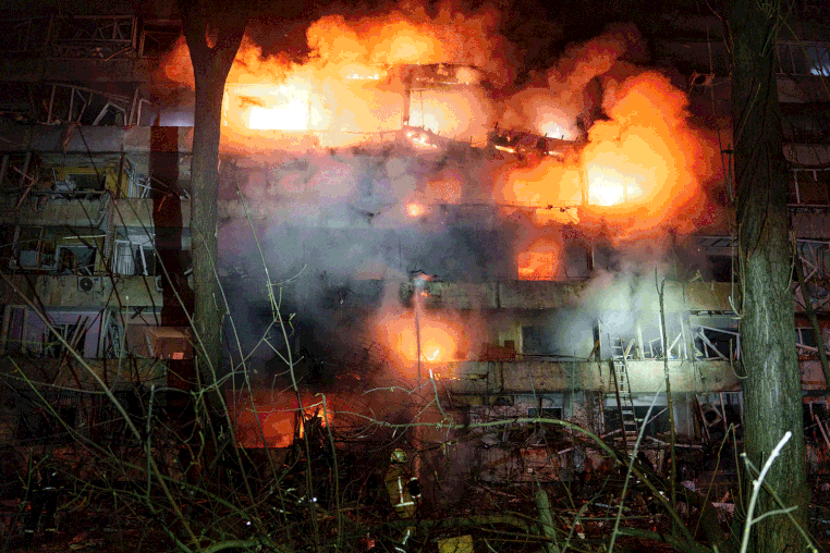 Image: A carousel of images from a missile strike on an apartment building, including the building ablaze, residents escaping and injured people on the ground outside.