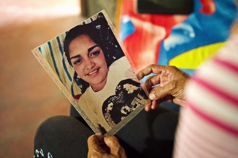 Aurimar Iturriago Villegas's mother looks at her photo at her home in Venezuela.