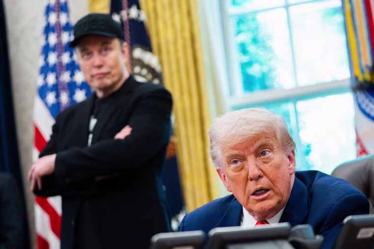 Elon Musk looks on as President Donald Trump speaks in the Oval Office on May 30, 2025. 
