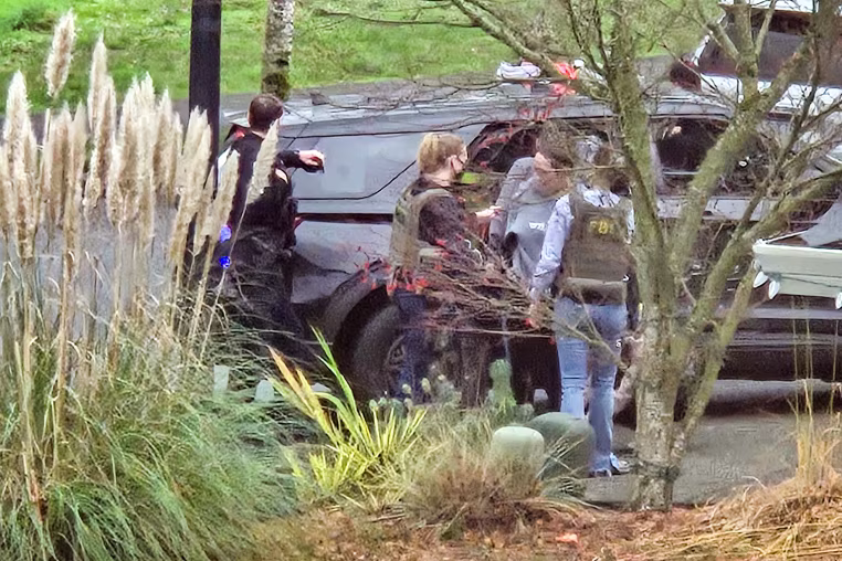 Law enforcement activity outside Megan Hall-Greenberg’s home in Washougal, Wash.