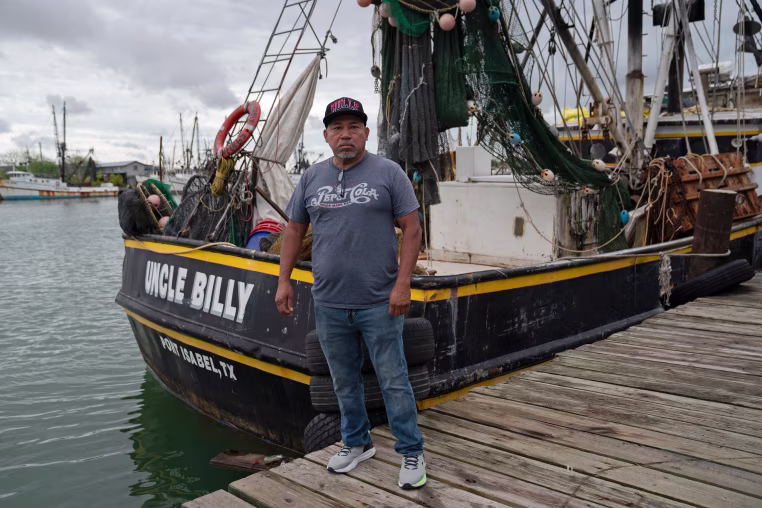 Wilmer Ruiz next to shrimp boat