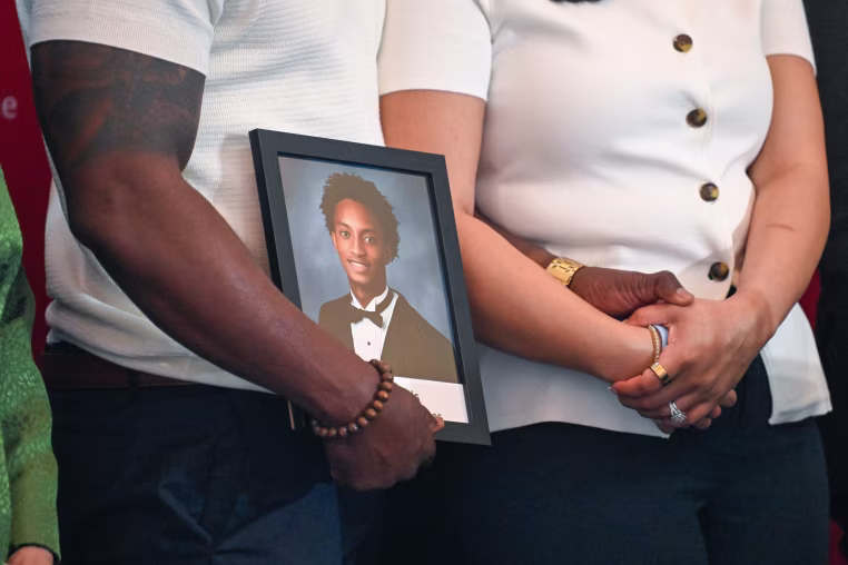 Nolan Wells photo frame is being held by his mother and step father.