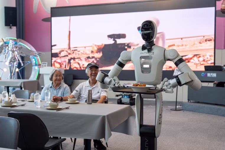 A humanoid robot serve a dish at the AI restaurant of the Global Pioneer AI Hub on Thursday, July 23, 2026 in Shenzhen, China.