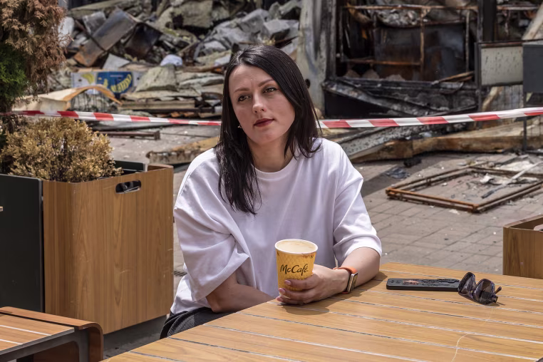 Image: Zlatoslava Supruniuk poses for a portrait outside McDonald's