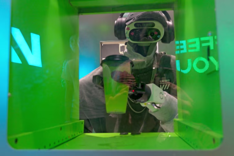 A robot barista makes makes drinks at the 7Fresh Coffee's coffee shop at Galaxy SOHO in Beijing.