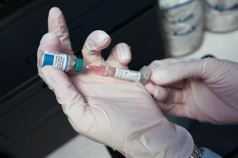 A Medical Assistant draws a measles, mumps and rubella, vaccination.