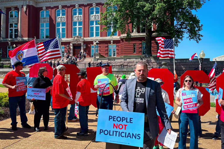 People protest in front of the state Supreme Court. 