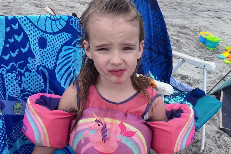 A 5 year old girl at the beach.