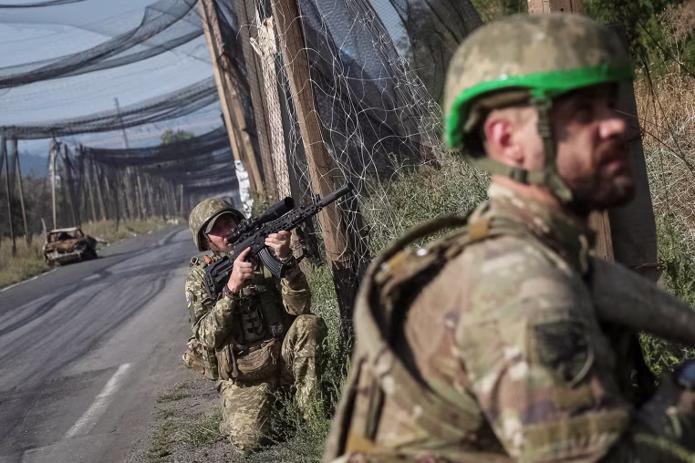 Ukrainian servisemen patrols a road near Kramatorsk