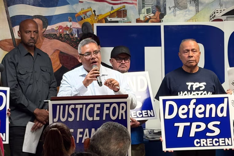 Image: Jose Palma speaking into a microphone and standing at a podium