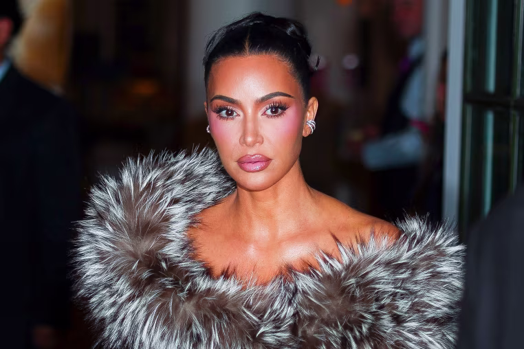 Image: Kim Kardashian with her hair tied back, wearing a fur shawl
