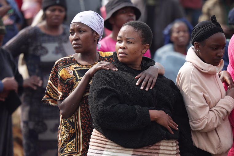 People gather near the crime scene where the body of a woman was discovered in Boksburg on September 17, 2026. 