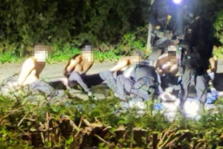 An image circulating on social media shows handcuffed suspects near RAF Fairford Air Base, England, on Sunday.