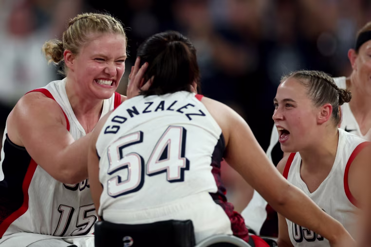 PARIS, FRANCE - SEPTEMBER 04: Rose Hollermann #15 and Ixhelt Gonzalez #54 of Team United States celebrate after their team's victory against Team Great Britain during the Wheelchair Basketball Women's Quarterfinal match between Team United States and Team Great Britain on day seven of the Paris 2024 Summer Paralympic Games at Bercy Arena on September 04, 2024 in Paris, France. (Photo by Steph Chambers/Getty Images)