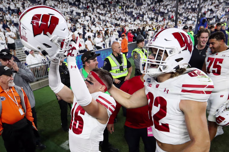 Sep 26, 2026; University Park, Pennsylvania, USA; Wisconsin Badgers safety Grant Dean (16) and wide receiver Dorsett Stecker (22) react while exiting the field following the game against the Penn State Nittany Lions at West Shore Home Field at Beaver Stadium. Mandatory Credit: Matthew O'Haren-Imagn Images