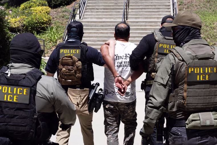 ICE agents walk a detainee out of the Ventura County Government Center in Ventura, CA.