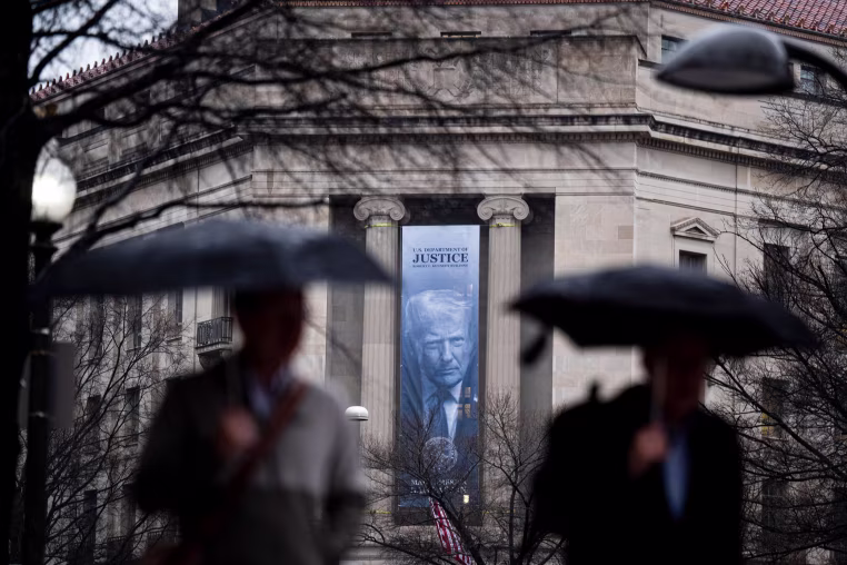 A banner of President Trump outside of the Department of Justice.