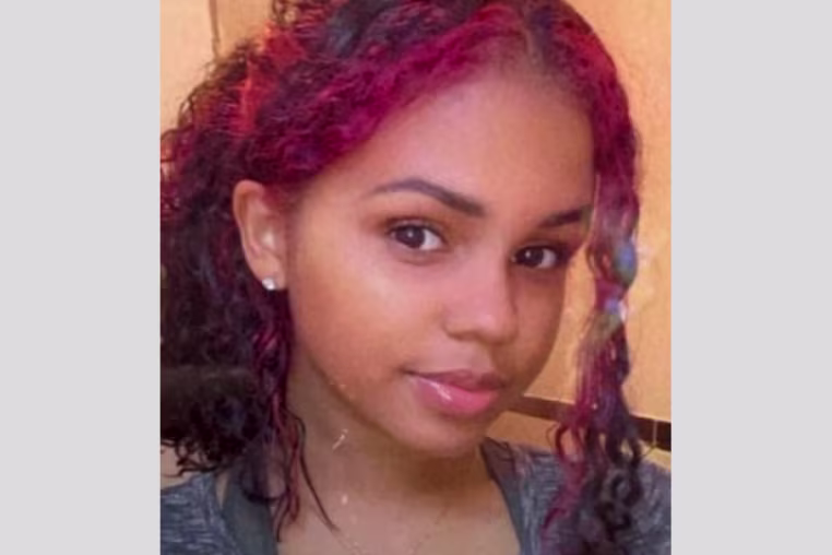 Nathaly Ramirez pictured with red hair in a ponytail, smiling at the camera