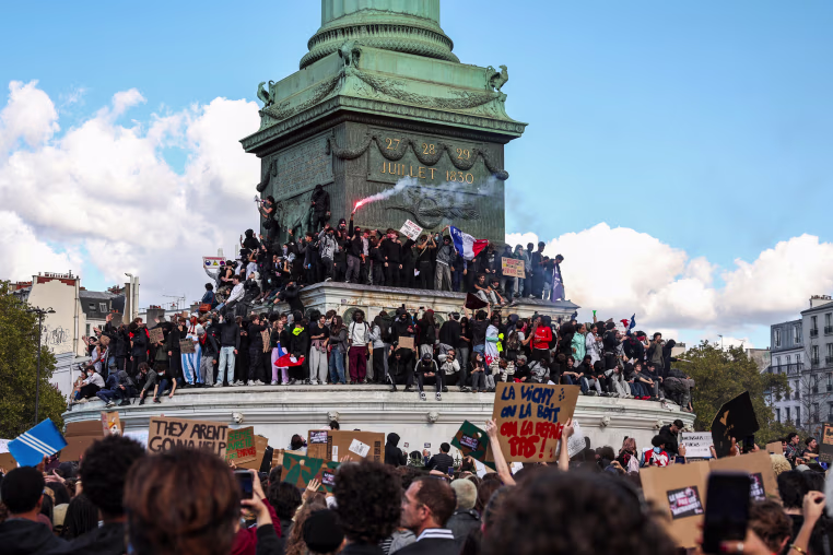 Protesters gather for a student demonstration at Place de la Bastille with a view of the Colonne de Juillet monument.