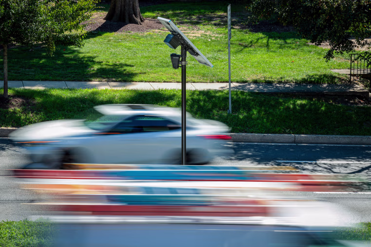 Flock camera as cars pass by.