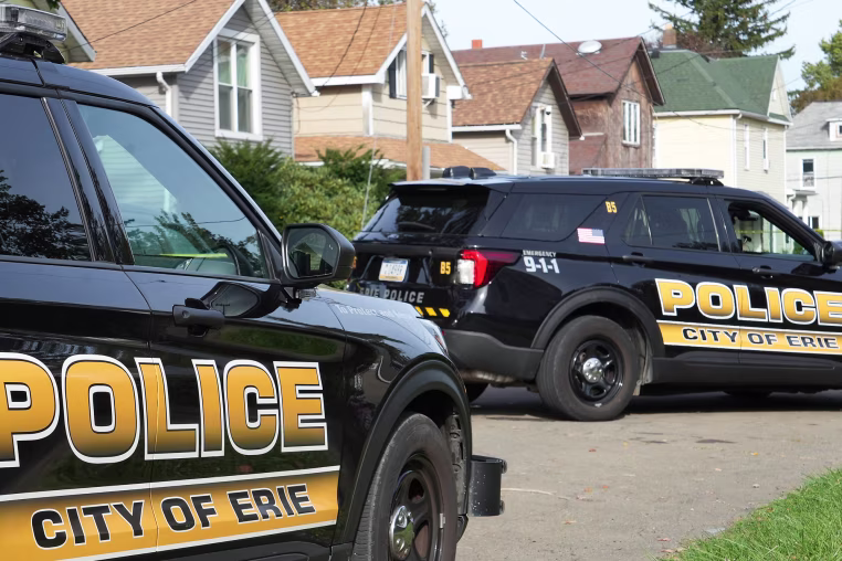 Erie Police cars parked outside on a residential street