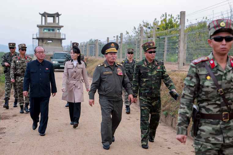 Kim Yo Jong, center left, walking amongst male soldiers.