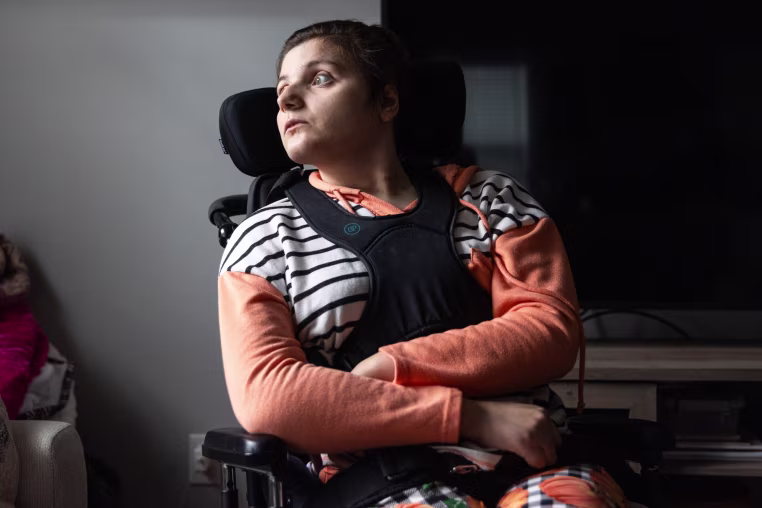 Lexi Kerro sits on a wheelchair and looks to the left of the frame